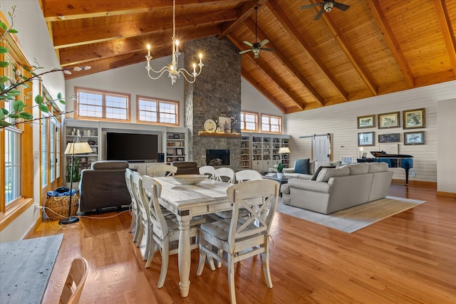 dining area with high vaulted ceiling, wooden ceiling, beamed ceiling, and ceiling fan with notable chandelier