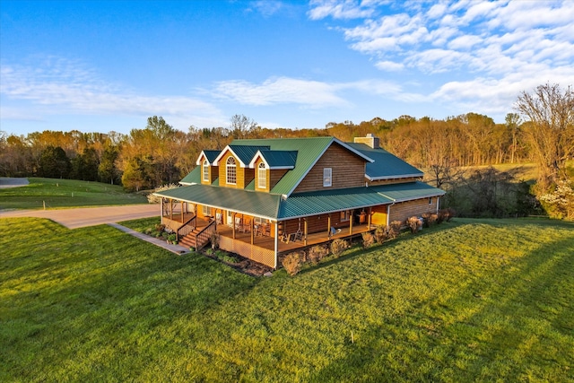 view of home's exterior with covered porch and a lawn