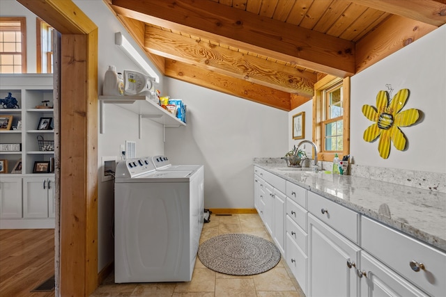 laundry area with hookup for a washing machine, cabinets, washer and clothes dryer, wood ceiling, and sink