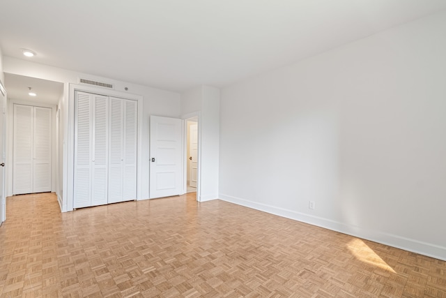 unfurnished bedroom with light parquet flooring