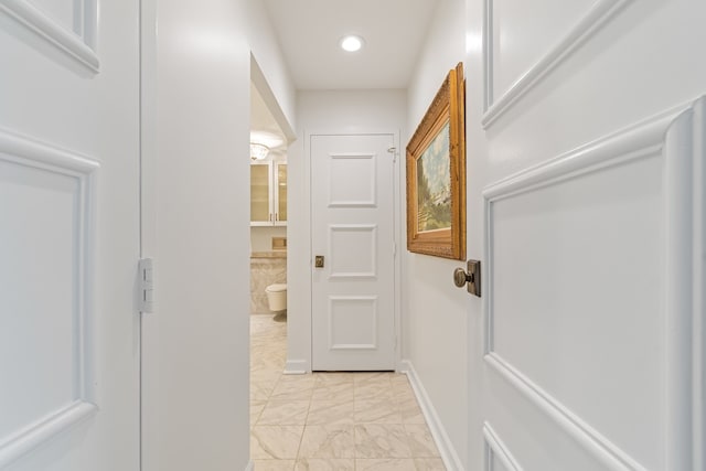 hall featuring light tile flooring