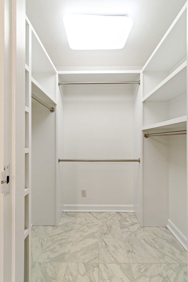 spacious closet featuring light tile flooring