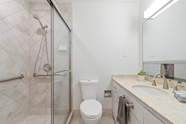 bathroom with a shower with door, toilet, tile floors, and vanity