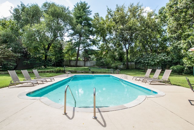 view of swimming pool featuring a patio and a lawn