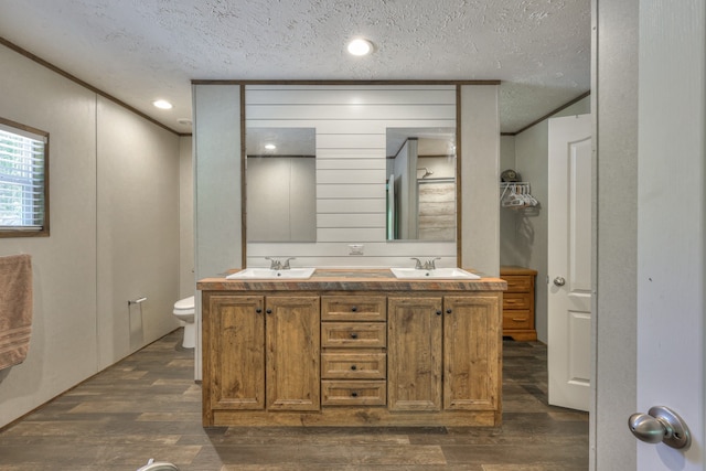 5077 Southpoint Ridge Rd, Hampshire, TN 38461 - bathroom with hardwood / wood-style flooring, a textured ceiling, toilet, and dual vanity