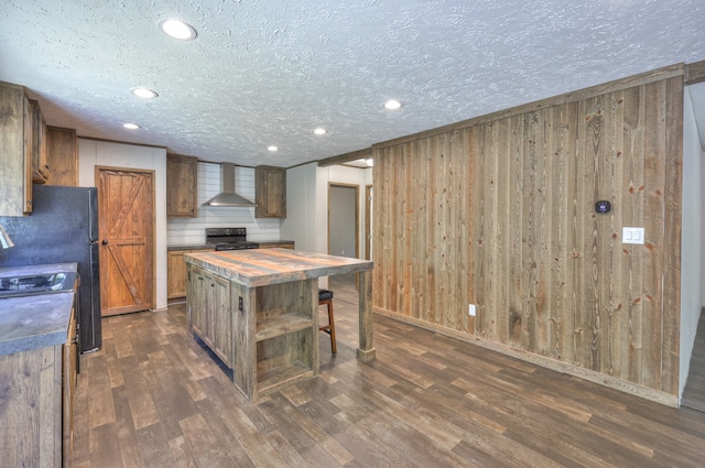 5077 Southpoint Ridge Rd, Hampshire, TN 38461 - kitchen featuring wall chimney exhaust hood, dark hardwood / wood-style floors, black appliances, a kitchen island, and butcher block counters