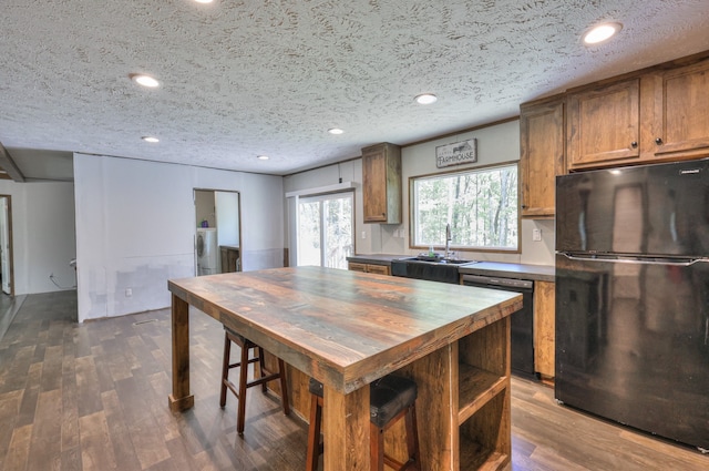 5077 Southpoint Ridge Rd, Hampshire, TN 38461 - kitchen with black appliances, dark hardwood / wood-style floors, a textured ceiling, wooden counters, and sink