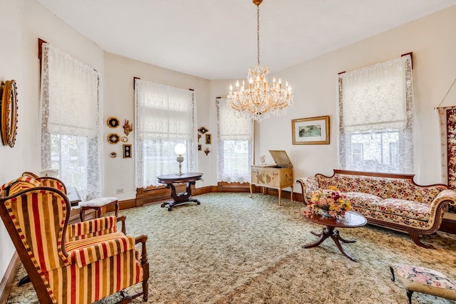 sitting room featuring plenty of natural light, carpet floors, and a chandelier