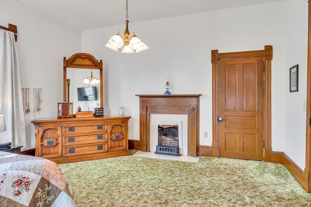 bedroom featuring carpet, a chandelier, and a wood stove