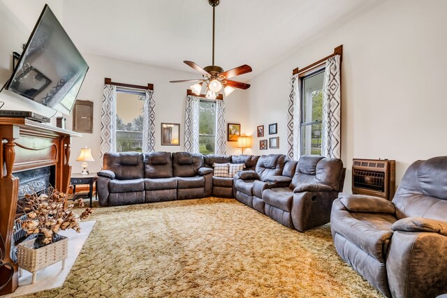 carpeted living room with plenty of natural light, ceiling fan, and heating unit