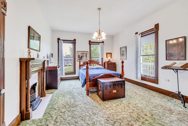 bedroom featuring a notable chandelier and light carpet