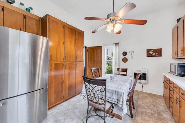 dining space featuring ceiling fan and heating unit