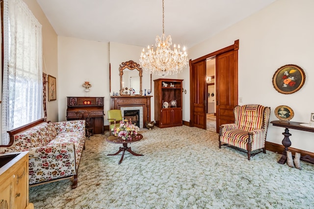 sitting room featuring carpet floors and a notable chandelier