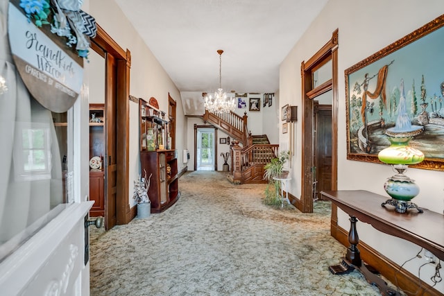 hallway featuring a chandelier, carpet floors, and plenty of natural light