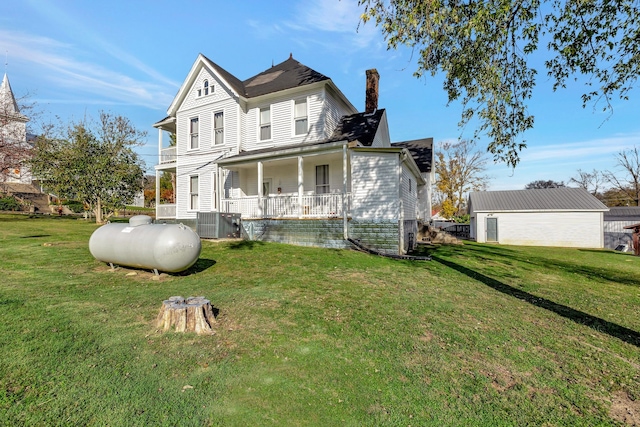 exterior space with covered porch, central air condition unit, and a front yard