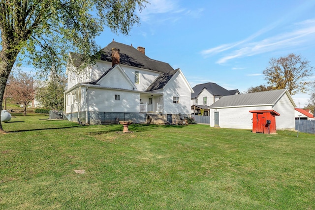 rear view of property with a lawn