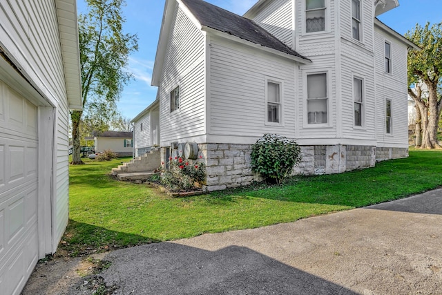 view of property exterior featuring a lawn