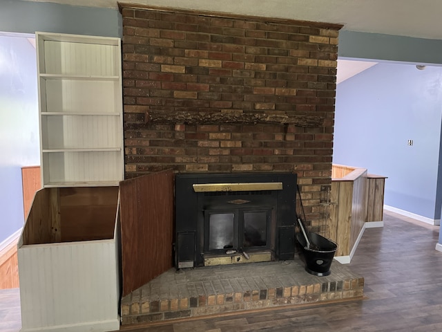 room details with a brick fireplace and dark hardwood / wood-style floors