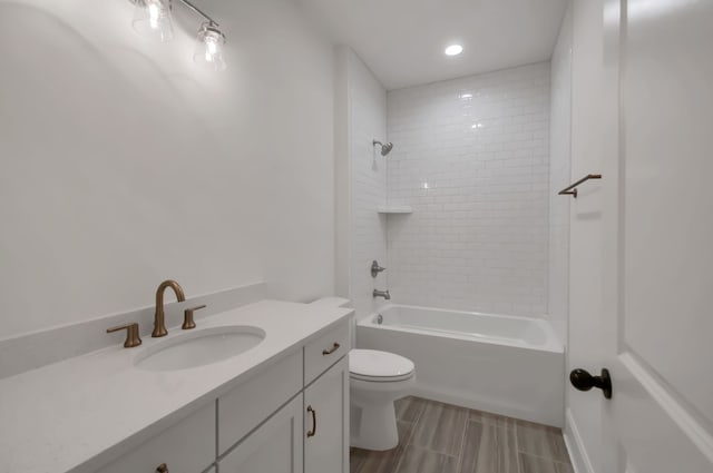 full bathroom with vanity, toilet, and tiled shower / bath