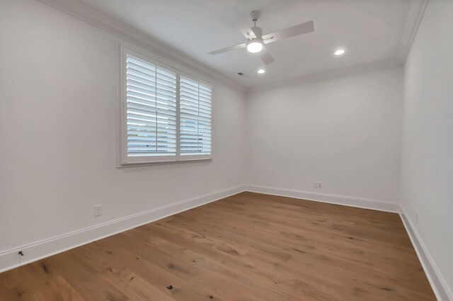 spare room with crown molding, wood-type flooring, and ceiling fan