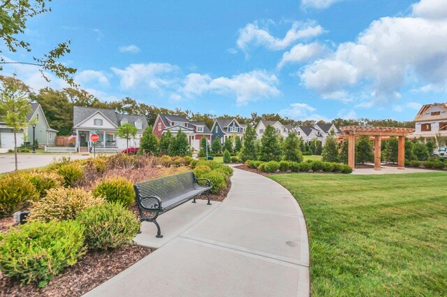 surrounding community with a pergola, a lawn, and a garage