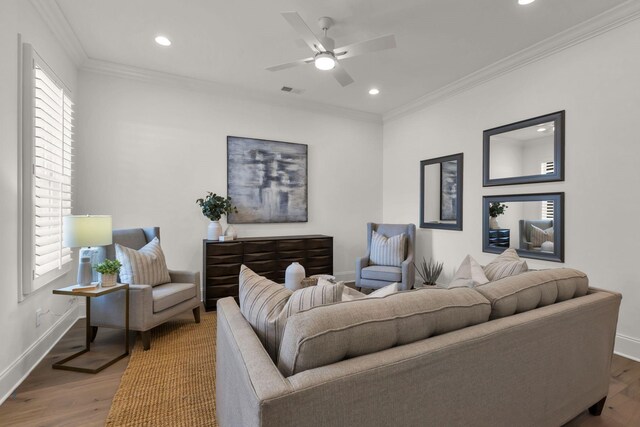 living room featuring crown molding, ceiling fan, and hardwood / wood-style floors