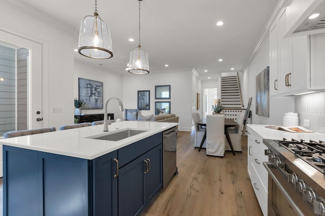 kitchen featuring blue cabinets, stainless steel appliances, sink, and white cabinets