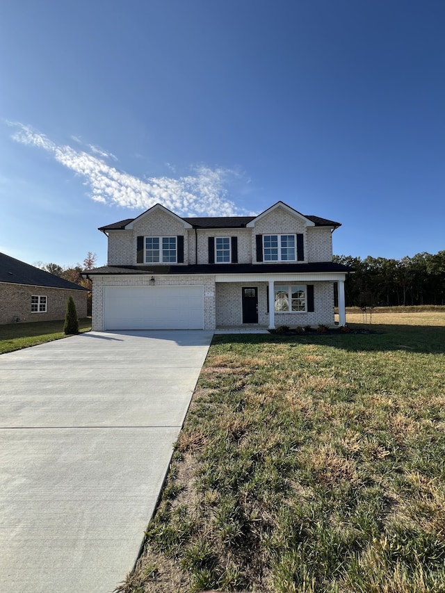 front of property with a front lawn and a garage