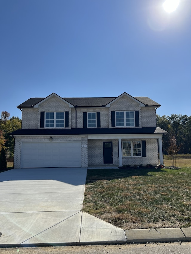 front of property featuring a garage and a front yard