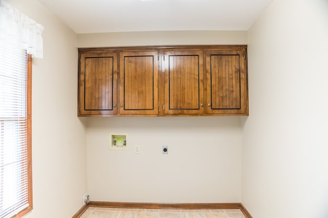 laundry area featuring hookup for an electric dryer, washer hookup, and cabinets