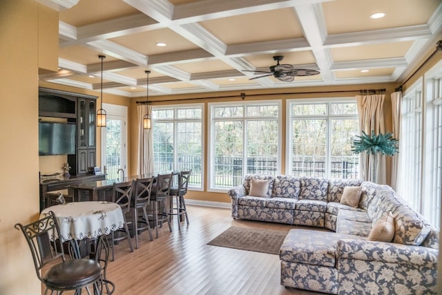 sunroom featuring ceiling fan, beam ceiling, and coffered ceiling