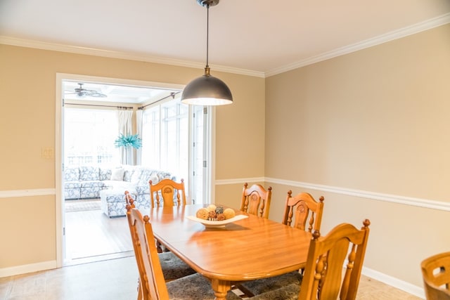 dining space featuring ceiling fan and ornamental molding