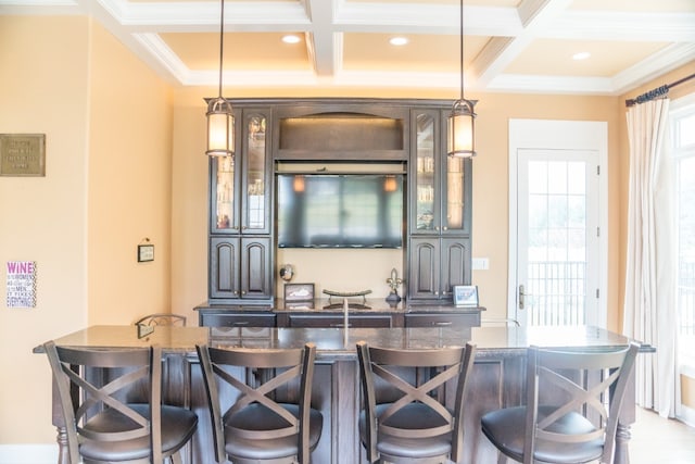 bar with coffered ceiling, beamed ceiling, dark stone countertops, pendant lighting, and ornamental molding