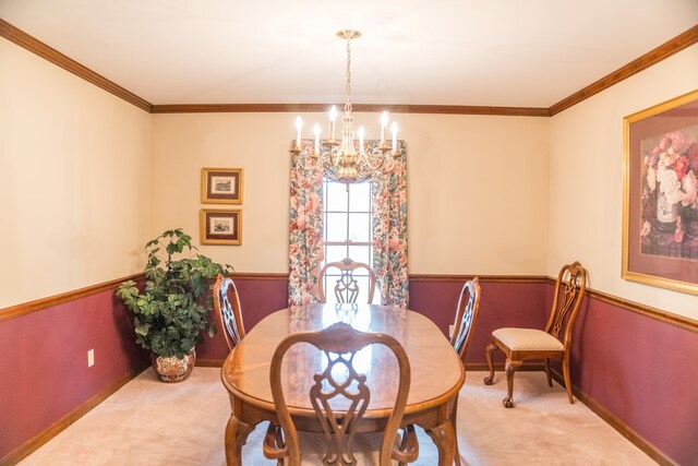 dining room with light carpet, ornamental molding, and a notable chandelier