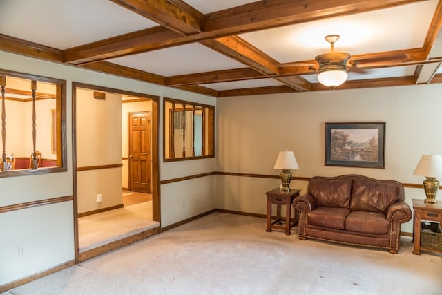 living room featuring beamed ceiling, light colored carpet, ceiling fan, and coffered ceiling