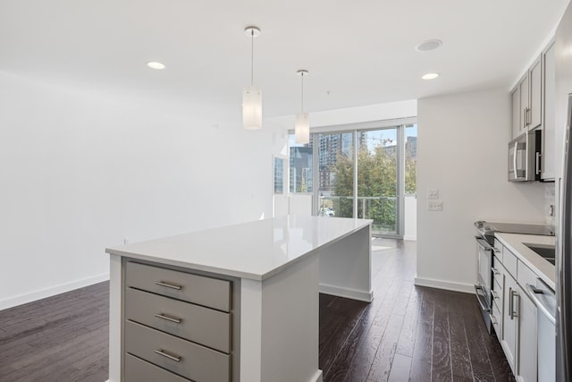 kitchen with a kitchen island, dark hardwood / wood-style flooring, stainless steel appliances, and decorative light fixtures