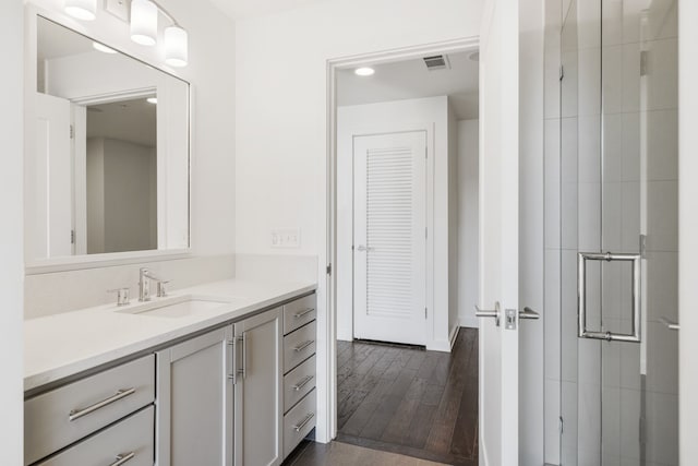 bathroom with hardwood / wood-style flooring and vanity