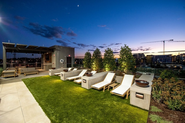 yard at dusk with a patio area and a pergola