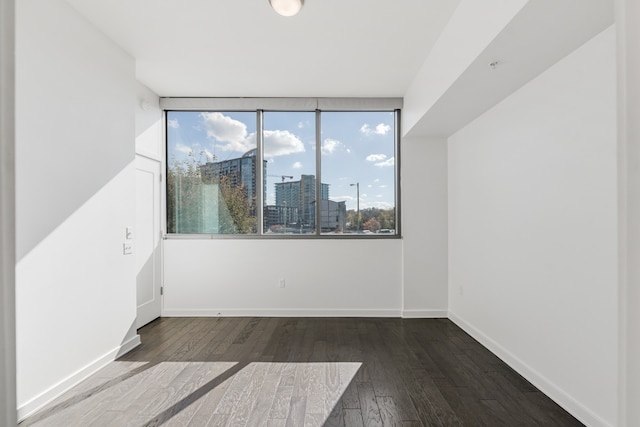 unfurnished room with a wealth of natural light and hardwood / wood-style floors