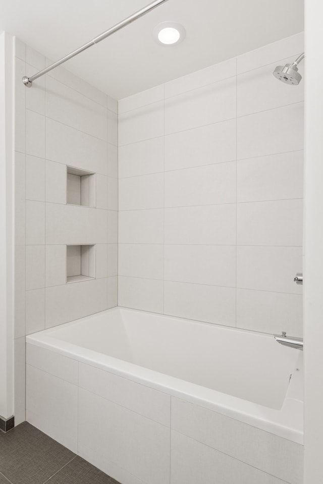 bathroom with tile flooring and tiled shower / bath