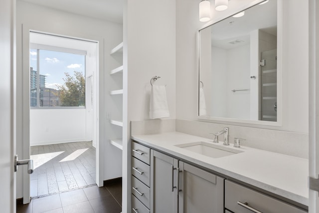 bathroom featuring tile flooring and vanity