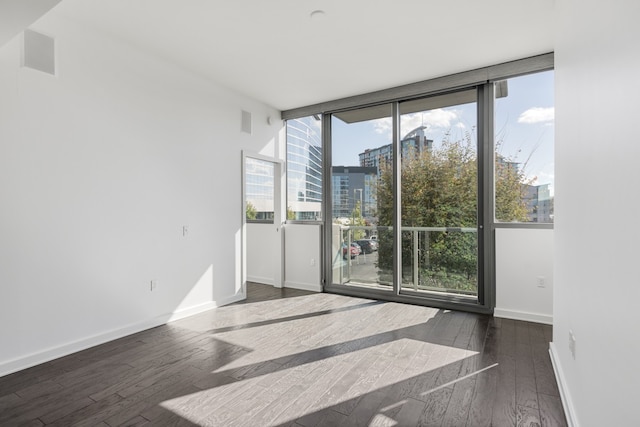 unfurnished room with dark hardwood / wood-style floors