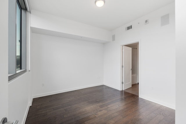 unfurnished room featuring dark wood-type flooring