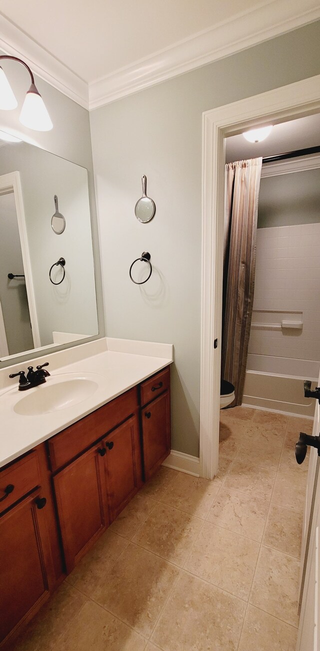 bathroom with vanity with extensive cabinet space, ornamental molding, and tile flooring