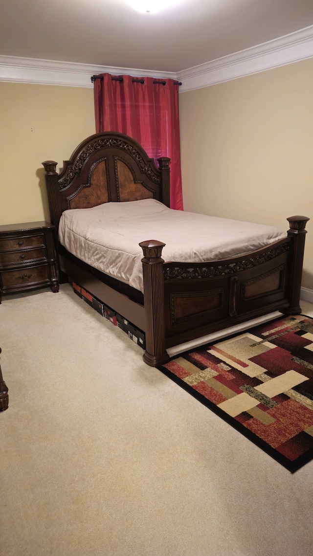 carpeted bedroom featuring crown molding