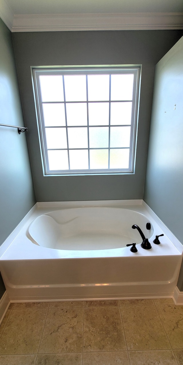 bathroom featuring a bath to relax in, crown molding, and tile flooring