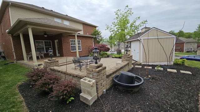 view of yard featuring a patio, an outdoor structure, and ceiling fan