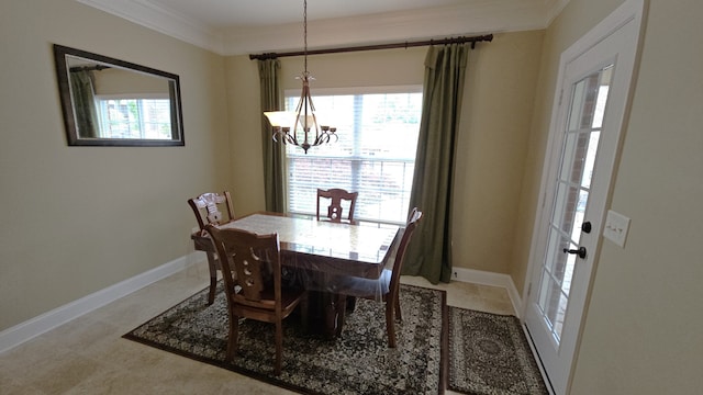 dining area featuring a wealth of natural light, a notable chandelier, and ornamental molding