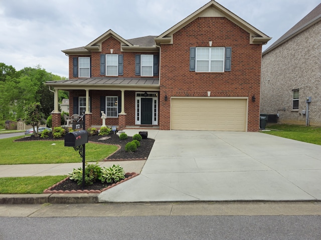 craftsman-style house featuring a garage, central AC, and a front lawn