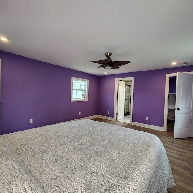 bedroom with ceiling fan, ensuite bathroom, and hardwood / wood-style flooring